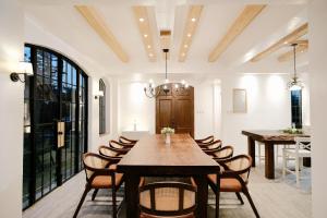 a dining room with a wooden table and chairs at The Old Country Stone House in Cebu City