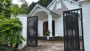 a white church with a gate in front of it at Tay Na Bon Homestay in Ha Giang