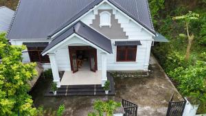 an overhead view of a white house with red doors at Tay Na Bon Homestay in Ha Giang