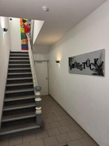 a staircase in a building with a sign on the wall at Hotel Jägerhof in Herne