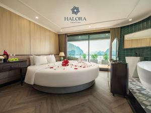 a hotel room with a large bed with roses on it at Halora Kairos Cruise in Ha Long