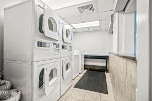 a laundry room with white washing machines in it at Ocean Park Resort in Myrtle Beach