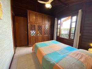 a bedroom with a bed and a large window at Paz na Serra Teresopolis Pet Friendly in Teresópolis +30 photos