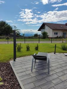 a table and a chair sitting on a patio at Ferienwohnung An Der Kapelle in Rickenbach +5 photos