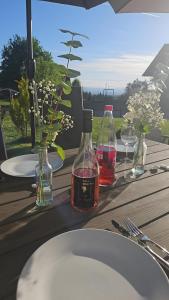a wooden table with two bottles of wine on it at Ferienwohnung An Der Kapelle in Rickenbach