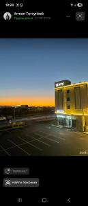 a view of a parking lot with a building at Qas-saQ in Türkistan