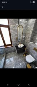 a bathroom with a sink and a toilet and a mirror at Qas-saQ in Türkistan +21 photos