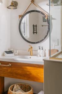 a bathroom with a sink and a mirror at Camp DeForest in Lincolnville +98 photos