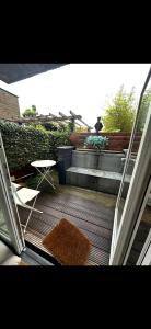 a balcony with a rug and a table and stairs at Appartement Plein 1944 in Nijmegen