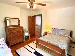 a bedroom with a bed and a dresser and a ceiling fan at Camden at Monticello in Salisbury