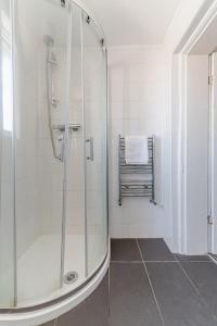 a shower with a glass door in a bathroom at No 3 Georgian Shared House - By Clifton Short Lets in Bristol