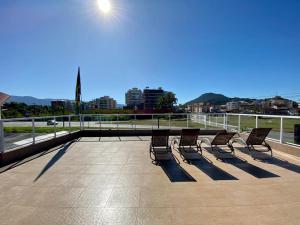 a group of chairs sitting on top of a roof at Pousada Werneck Residence Suites in Ubatuba
