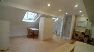 an attic room with a desk and a window at L'entracte in Hensies +1 photo