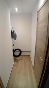 a door leading to a room with a toilet at L'entracte in Hensies