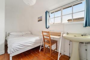 a small bedroom with a bed and a sink at No 3 Georgian Shared House - By Clifton Short Lets in Bristol +6 photos