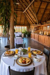 a table with plates of food on it in a restaurant at Linglela Lodge in Estcourt