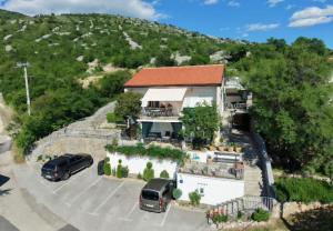 a house with cars parked in a parking lot at Apartmens Mendula in Senj +95 photos