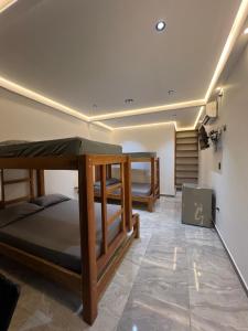 a room with two bunk beds and a staircase at Hotel Magic Capurganá in Capurganá +65 photos