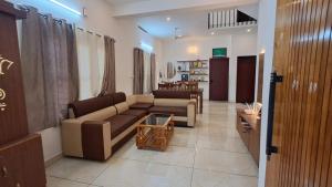 a living room with a couch and a table at Kodikkakkam Homestay in Kappil