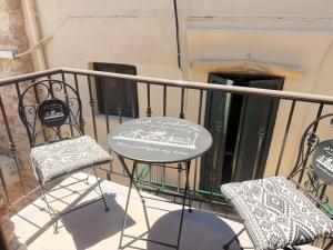 ein Tisch und zwei Stühle auf einem Balkon in der Unterkunft Mastic Nest in Chios