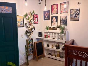 a room with a shelf and pictures on the wall at Blomst Casa Hostal in Jericó
