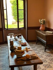 a table with food on it in a living room at La Maison du 19 in Cluny