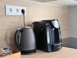 a coffeemaker and a coffee maker sitting on a counter at Apartman H4 in Žilina