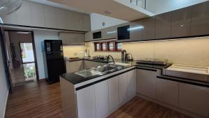 a large kitchen with a sink and a stove at Kodikkakkam Homestay in Kappil +19 photos