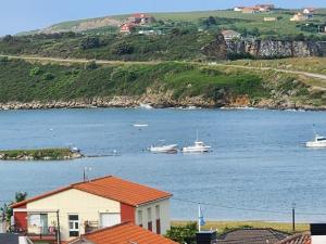 a view of a body of water with boats in it at Apartamento Riberuca Playa in Suances