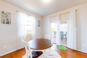 a dining room with a wooden table and chairs at Seaside Village --- #3 in Ocean City