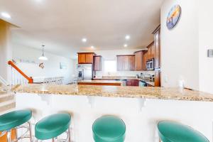 a kitchen with green stools at a counter at Seaside Village --- #3 in Ocean City