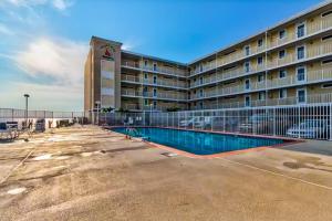 a hotel with a swimming pool in front of a building at Wight Bay North #439 in Ocean City