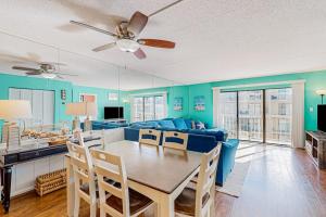 a living room with a table and a blue couch at Wight Bay North #439 in Ocean City +17 photos