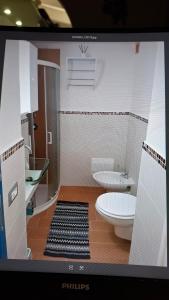 a bathroom with a toilet and two sinks at PortoPollo SurfHouse C in Barrabisa +51 photos