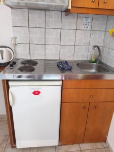 a small kitchen with a sink and a stove at studios Katerina A Lentas in Lentas +15 photos