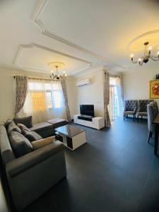 a living room with a couch and a table at Résidence les Palaja in Douala