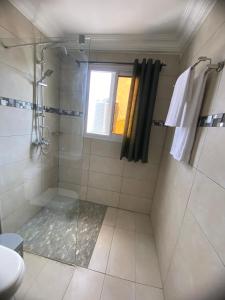 a bathroom with a shower and a window at Résidence les Palaja in Douala +6 photos