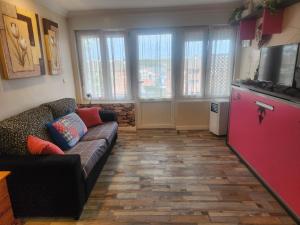 a living room with a couch and a tv at Apartamento Riberuca Playa in Suances