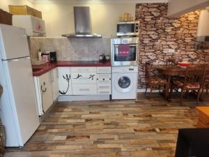 a kitchen with a washer and dryer and a table at Apartamento Riberuca Playa in Suances