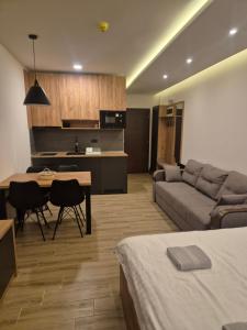 a living room with a couch and a table and a kitchen at Hill residence A 119 Boby in Cajetina