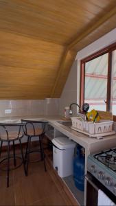 a kitchen with two stools and a counter top at La Casita de Merme in Oxapampa