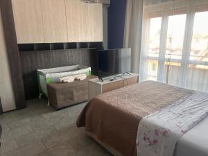 a hotel room with a bed and a window at Dante appartamento in Fagnano Olona