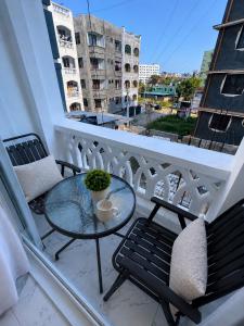 a balcony with a glass table and two chairs at Peace Nest bamburi in Mombasa