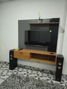 a flat screen tv sitting on top of a entertainment center at 2 bedroom super cozy apartment in Accra