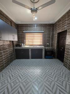 an empty kitchen with a ceiling fan in a room at 2 bedroom super cozy apartment in Accra