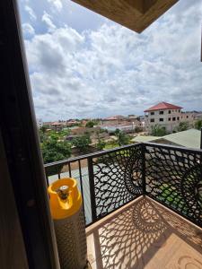 a balcony with a trash can and a view of a city at 2 bedroom super cozy apartment in Accra
