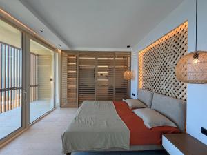 a bedroom with a bed and a balcony at Villa Azul in Palasë +32 photos