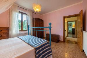 a bedroom with a bed and a window and a mirror at CASALE LE CONCE 6, Emma Villas in Castel del Piano +34 photos