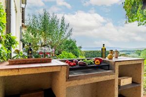 a outdoor kitchen with fruits and vegetables on a table at CASALE LE CONCE 6, Emma Villas in Castel del Piano