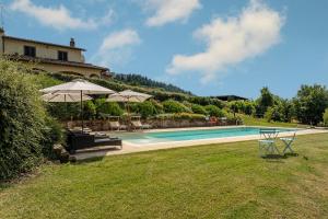 a swimming pool in a yard with a house at CASALE LE CONCE 6, Emma Villas in Castel del Piano
